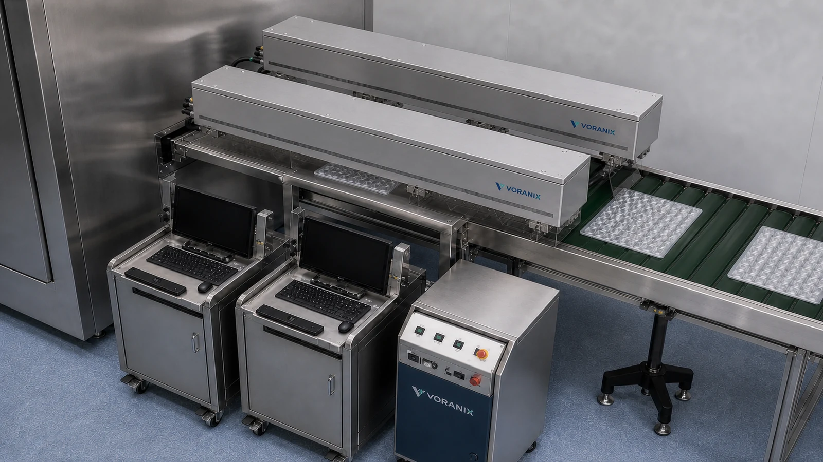 Two identical long-body VORANIX UV picosecond laser units above a BFS eye drop packaging line