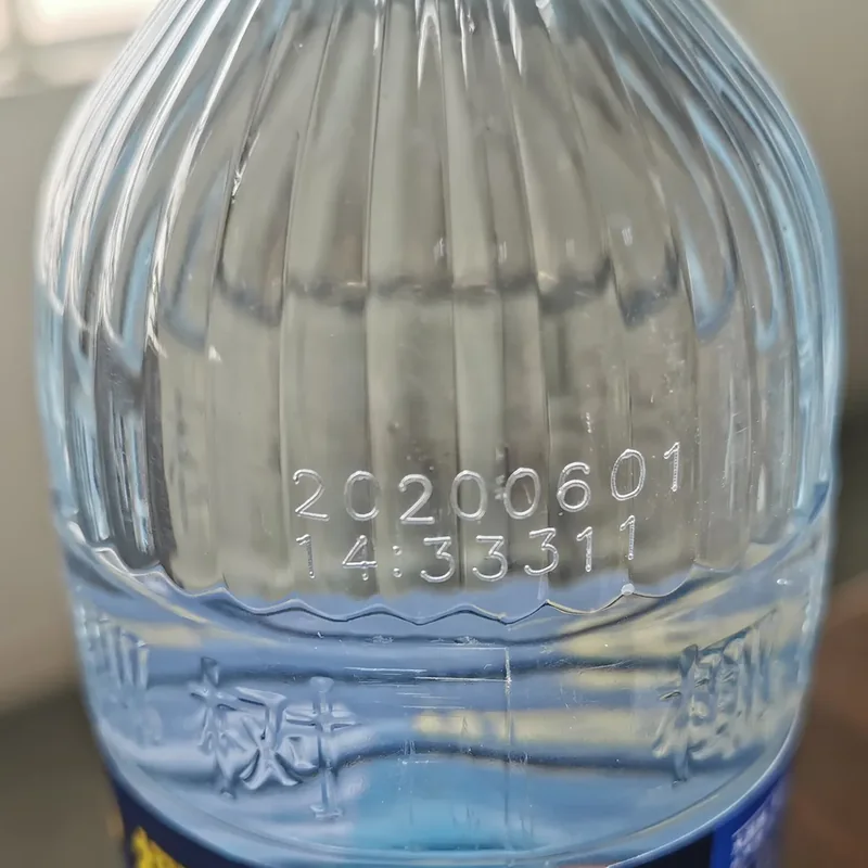 CO2 laser date code on a clear bottle