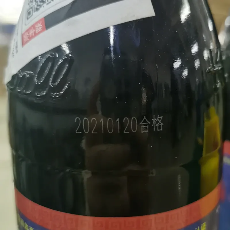 CO2 laser date code marking on a glass bottle