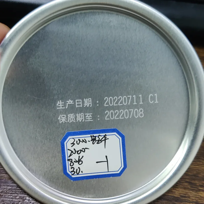 Fiber laser date code marking on a metal lid