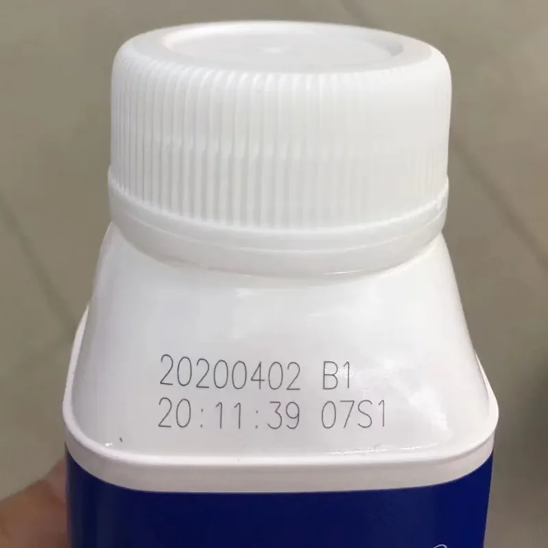 UV laser date code on a white beverage bottle