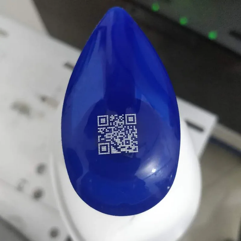 UV laser QR code marking on a blue plastic part