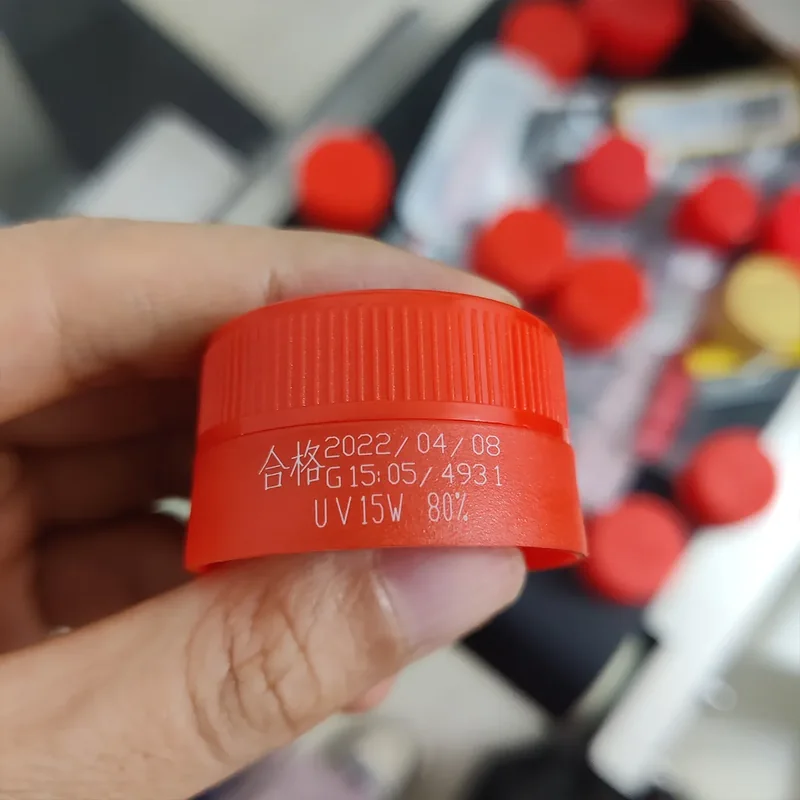 UV laser date and text code on a red plastic cap